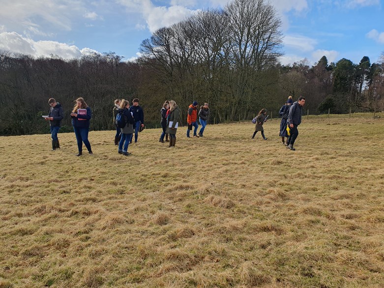 A group of people standing in a field.