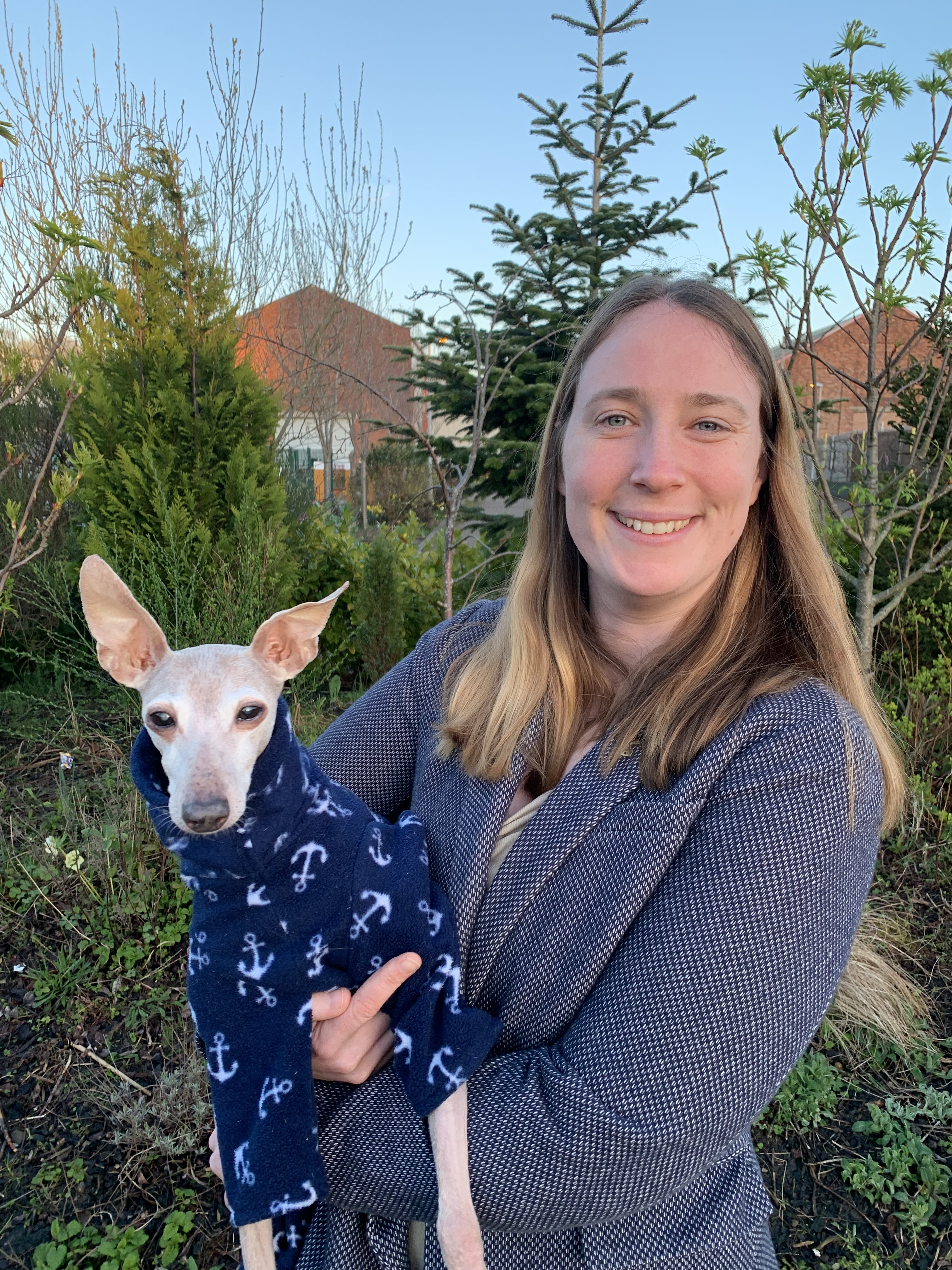 Smiling woman holding her small dog